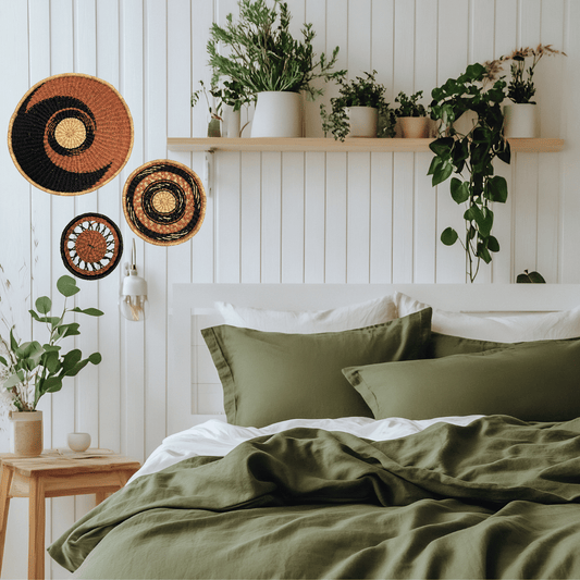 Bedroom with green bedding, decorative pillows, and basket wall art on a white paneled wall.