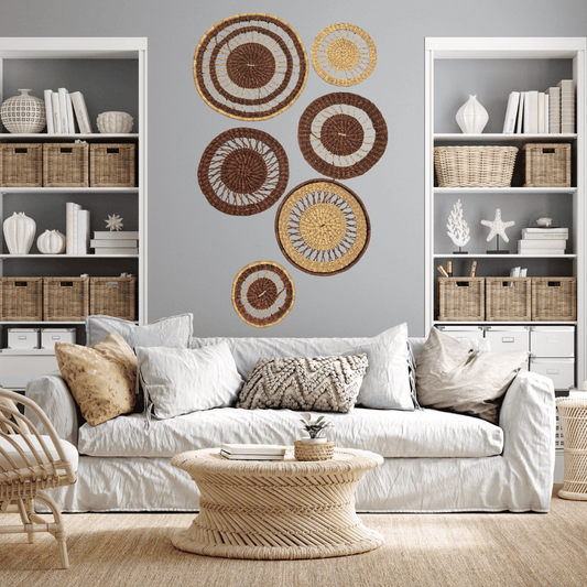 Living room with a white sofa, decorative pillows, and basket wall art.