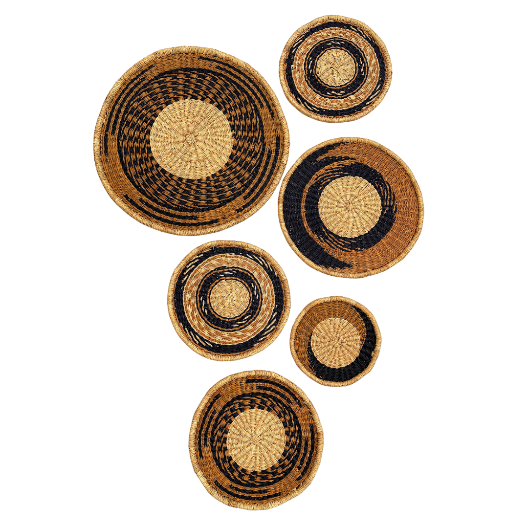 Set of woven wall baskets with black and natural patterns on a white background