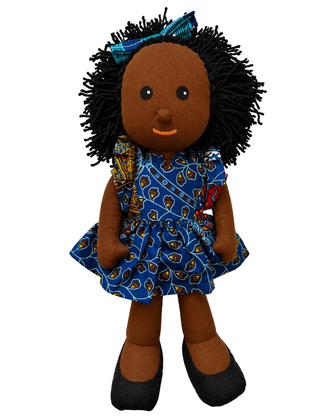 A handmade African American doll with black yarn hair and a blue patterned dress, shown against a plain white background.