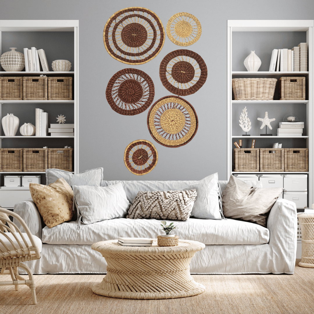 Living room with a white sofa, decorative pillows, and basket wall art.