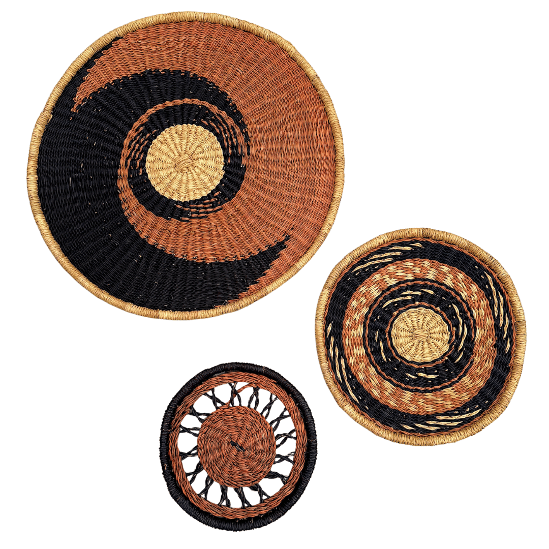 Three woven baskets with concentric circle patterns on a white background