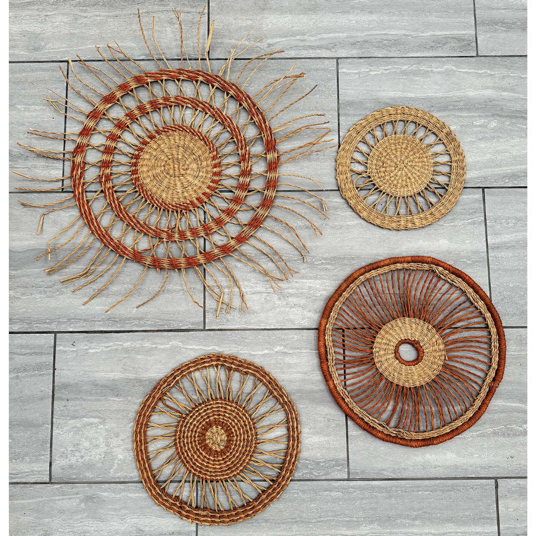Set of four woven wall art pieces on a wooden surface