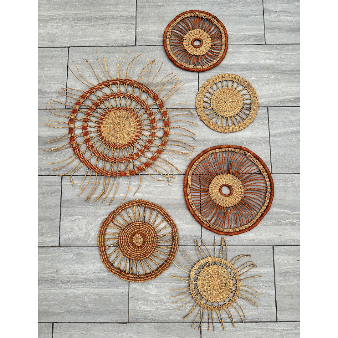 Set of woven wall basket art pieces on a wooden surface