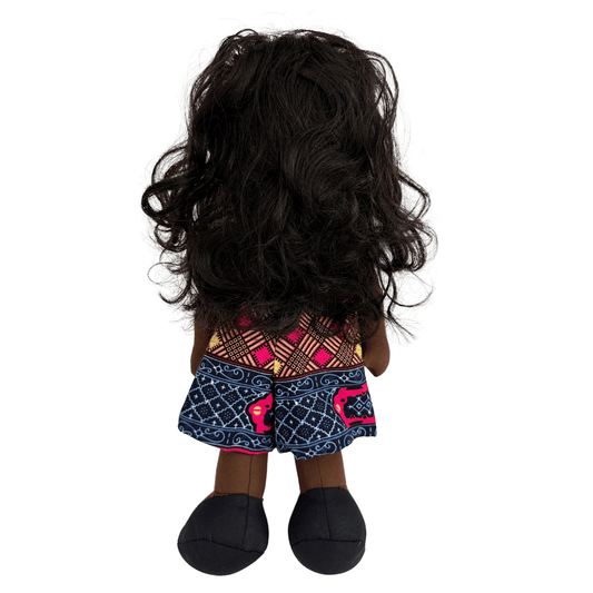 Doll with long black hair and a colorful patterned dress ankara fabric