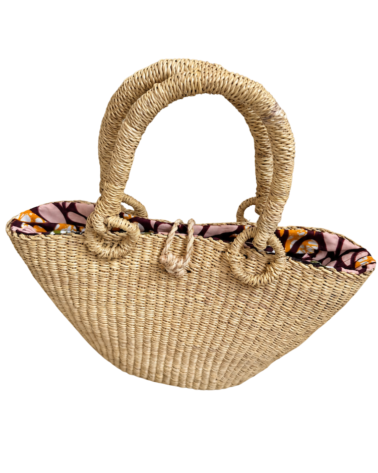 Handwoven straw handbag standing upright