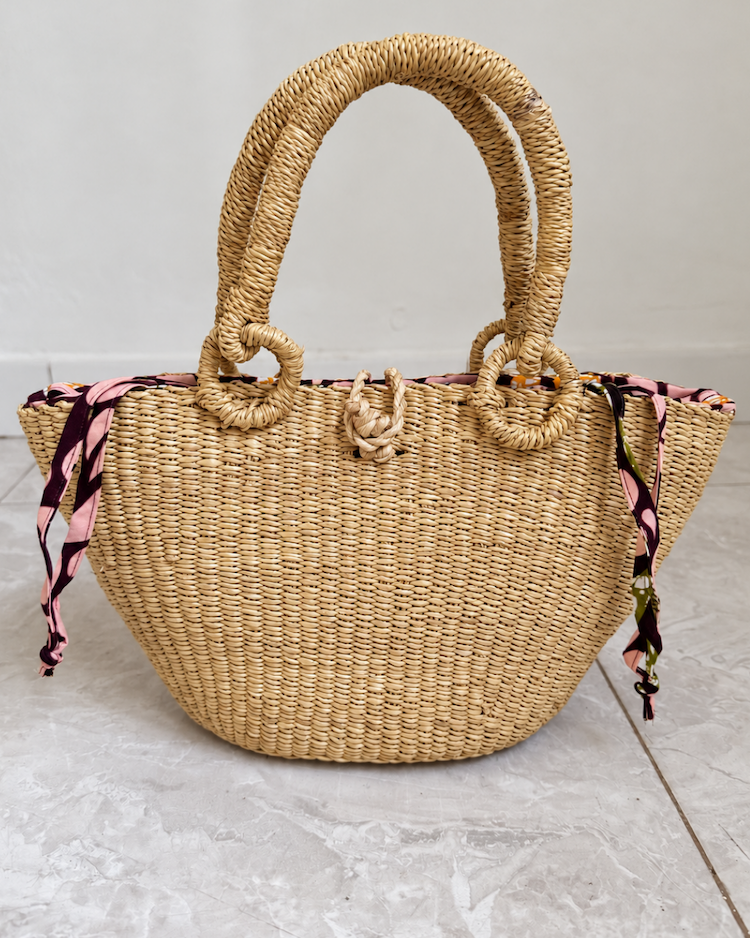 Handwoven straw handbag standing upright