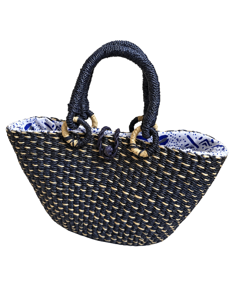 Angled front view of the handwoven straw handbag