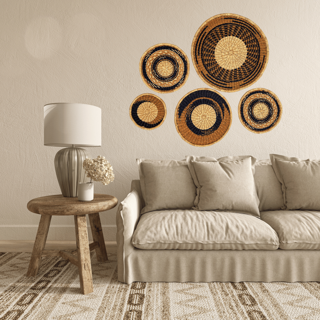 Living room with beige sofa, wooden side table, and decorative woven baskets on the wall.