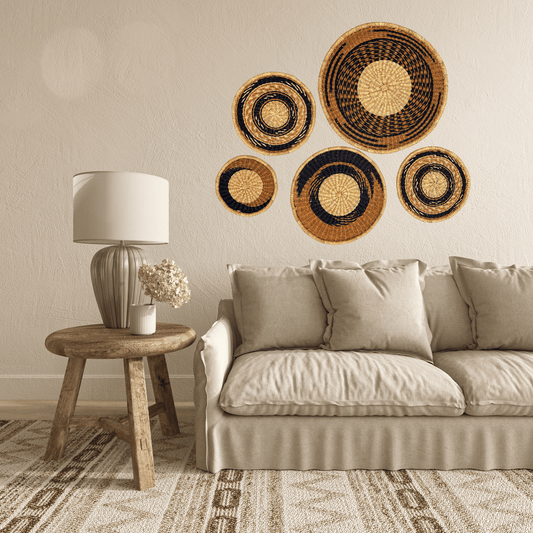 Living room with beige sofa, wooden side table, and decorative woven baskets on the wall.