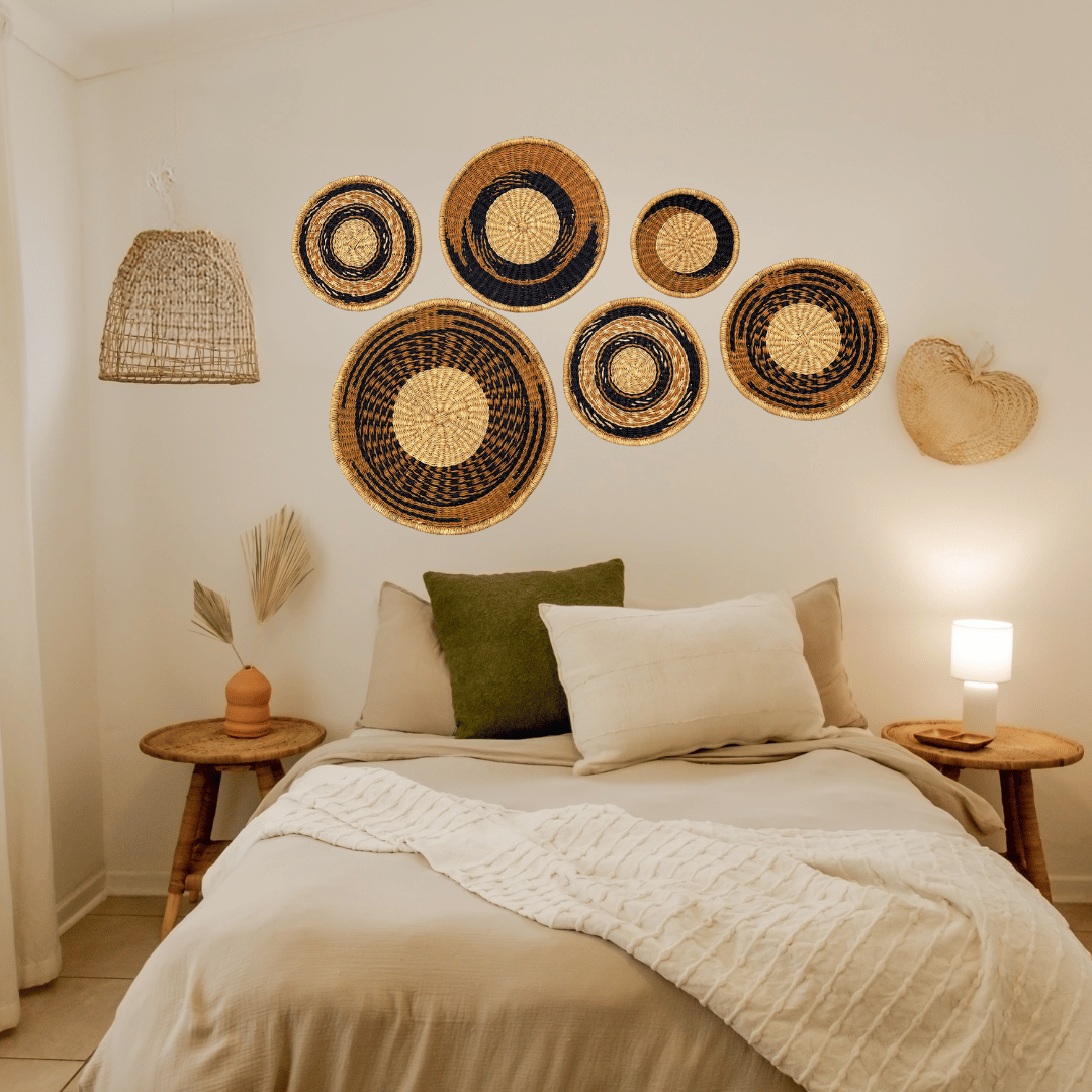 Decorative wall baskets on a bedroom wall with a bed and side tables.
