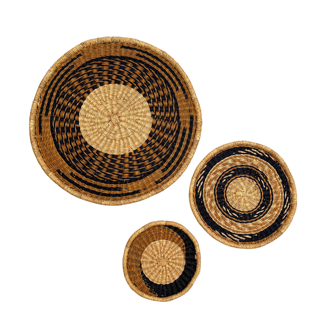Set of three woven baskets with black and natural patterns on a white background