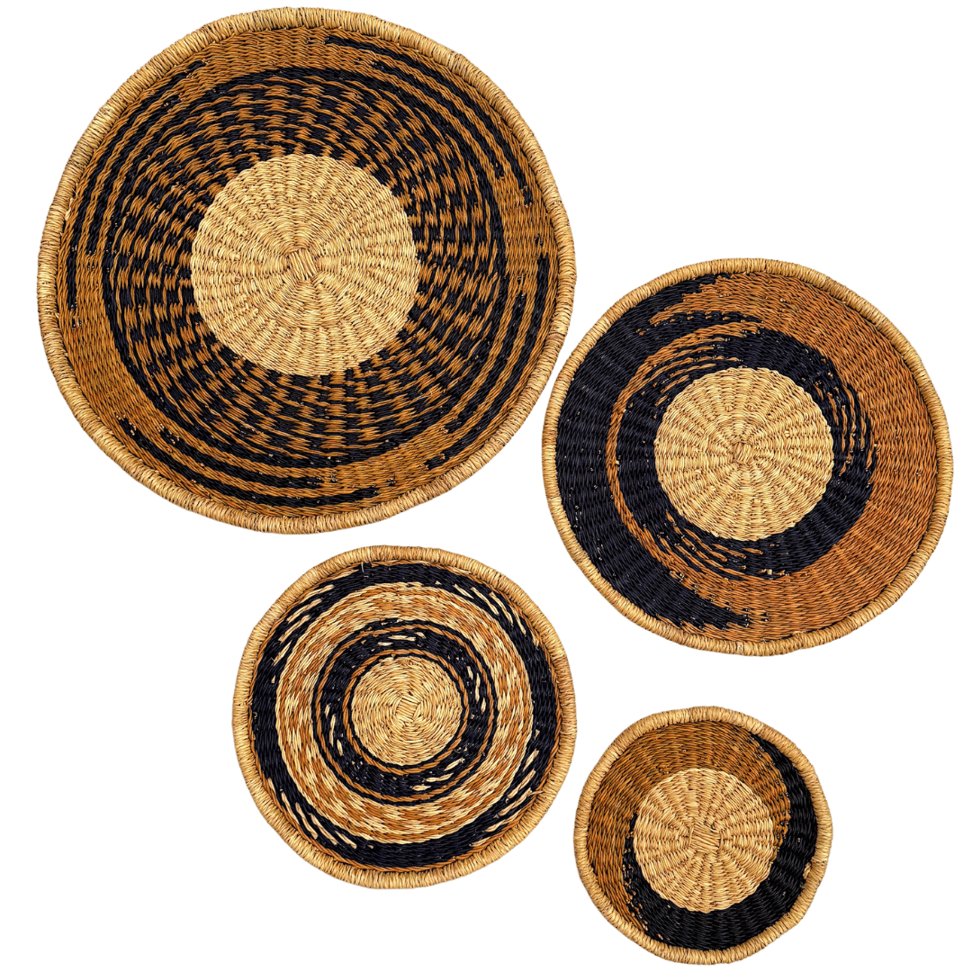 Set of four woven wall baskets with black and natural patterns on a white background