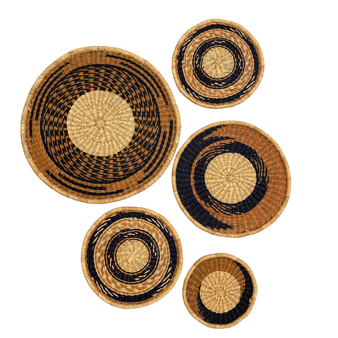 Set of woven wall baskets with black and natural patterns on a white background