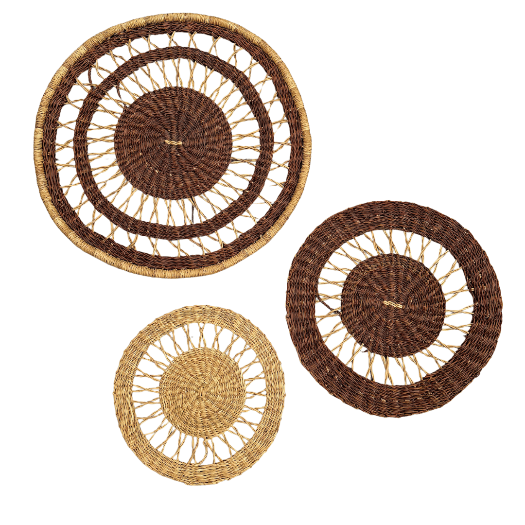 Set of three woven wall baskets in brown and beige on a white background