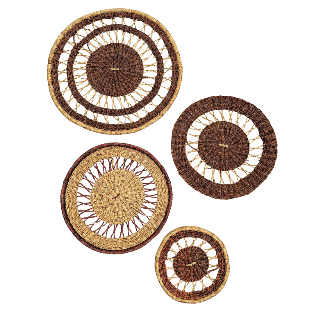 Set of four woven wall baskets in varying sizes on a white background