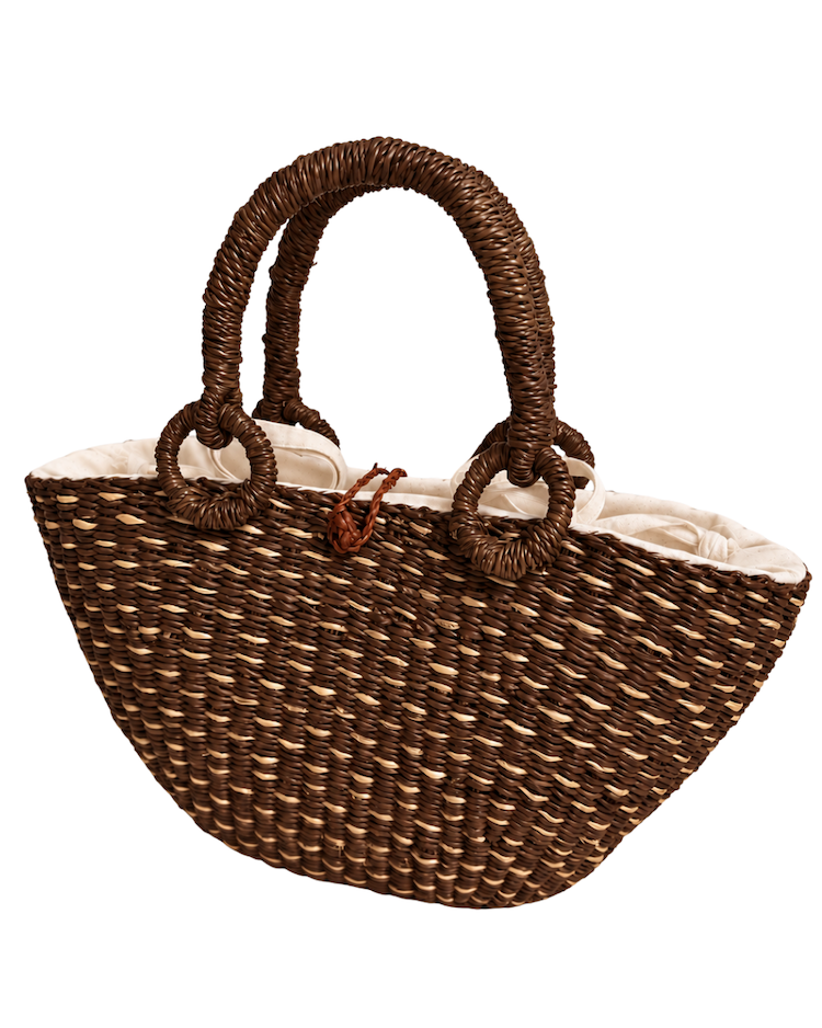 Angled front view of the handwoven straw handbag