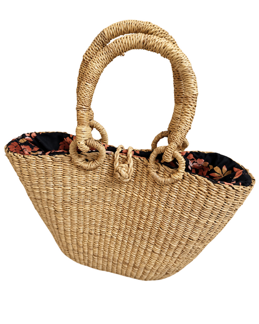 Angled front view of the handwoven straw handbag