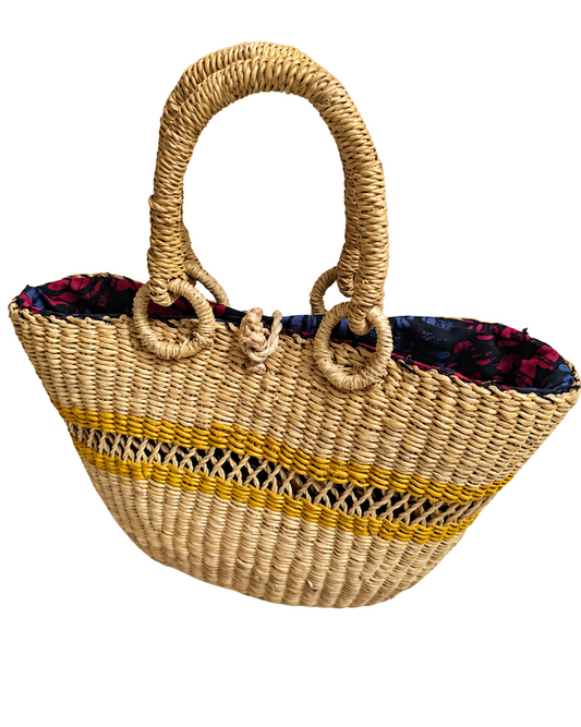 Angled front view of the handwoven straw handbag