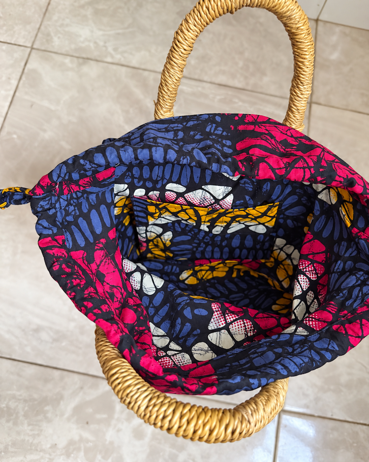 Handwoven straw handbag with its lining open
