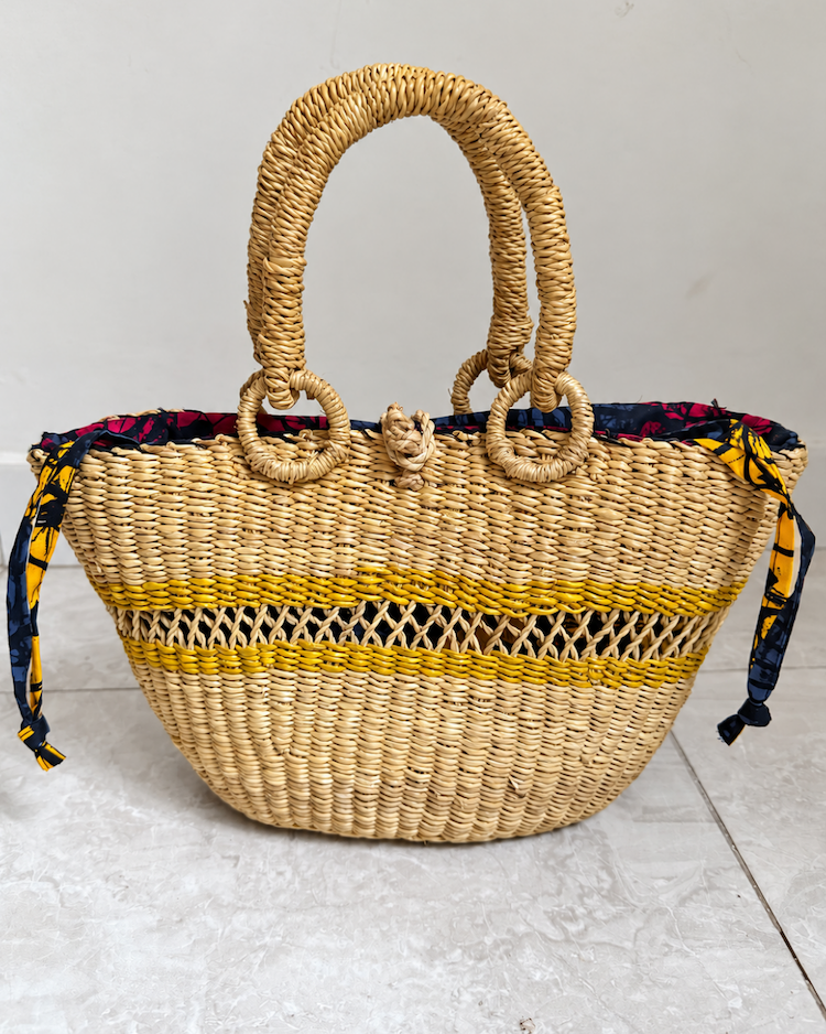 Handwoven straw handbag standing upright