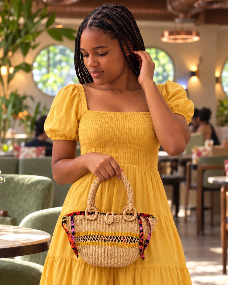 Model carrying the straw handbag over her arm