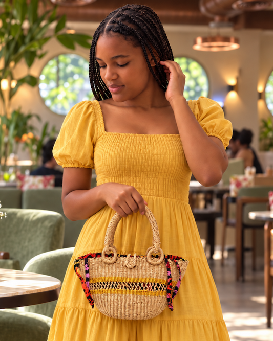 Model carrying the straw handbag over her arm