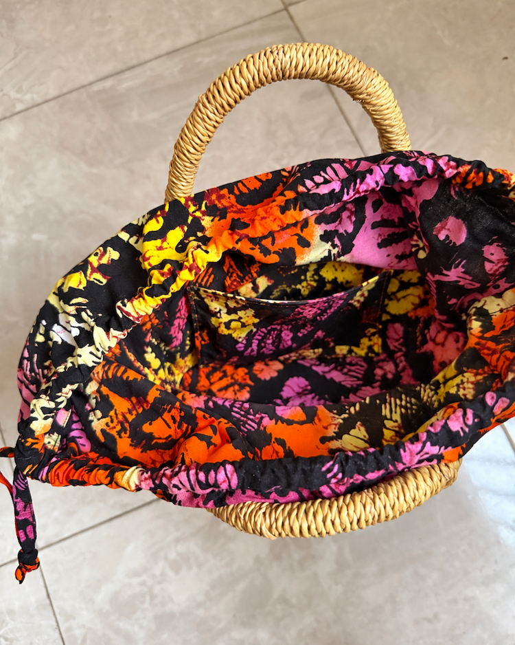 Handwoven straw handbag with its lining open
