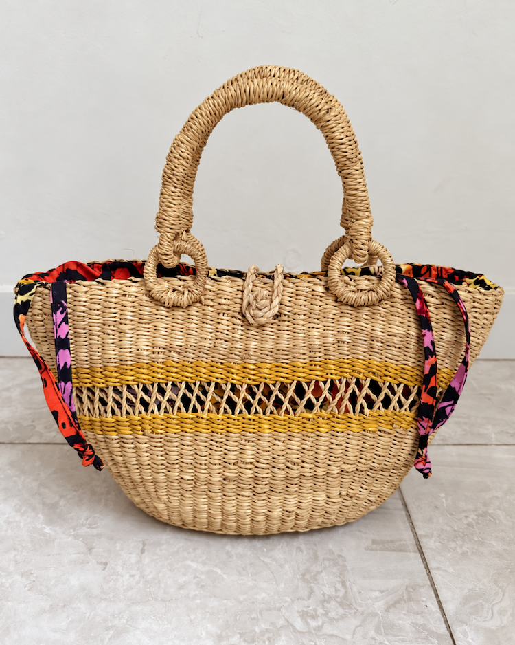 Handwoven straw handbag standing upright