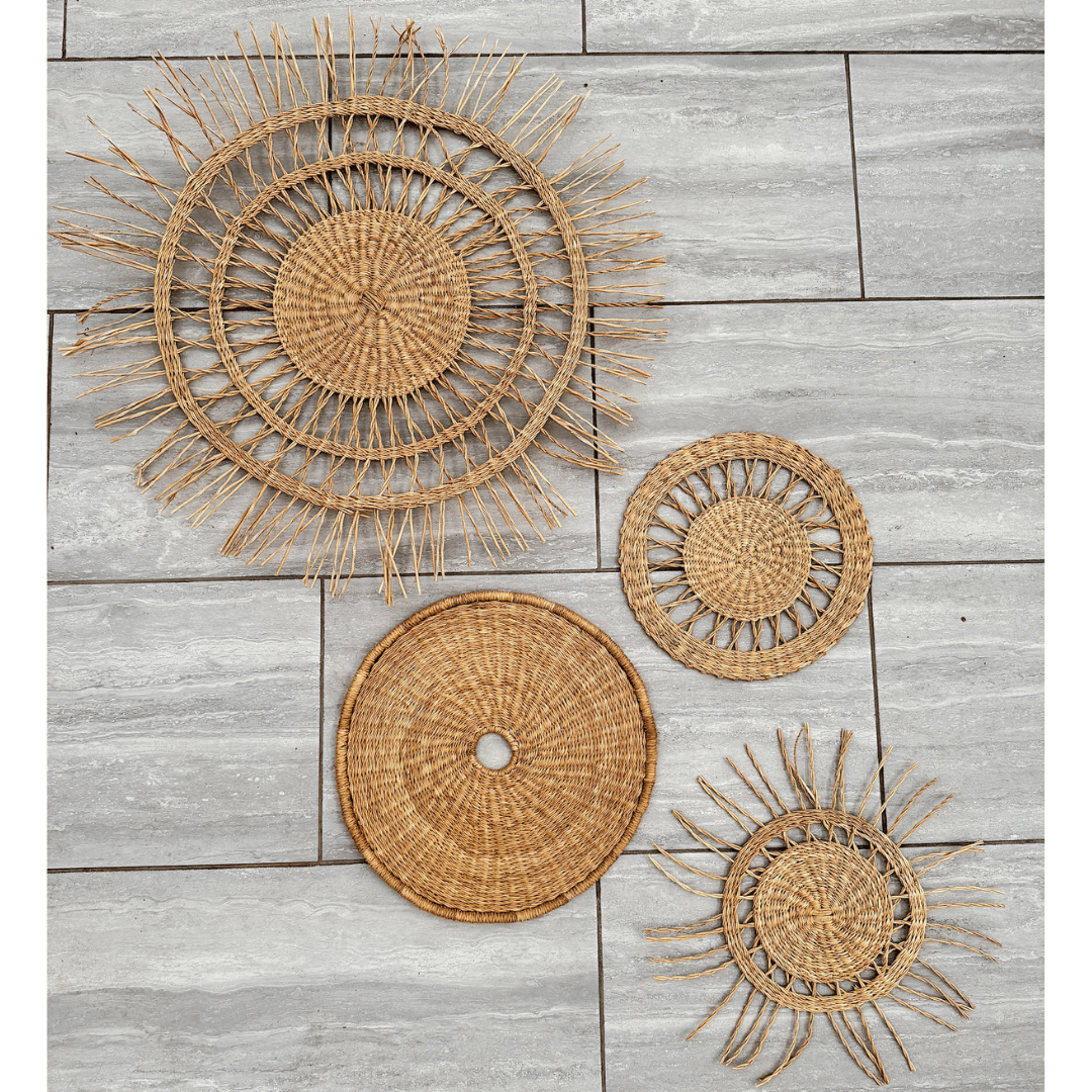 Set of woven wall art pieces on a wooden floor