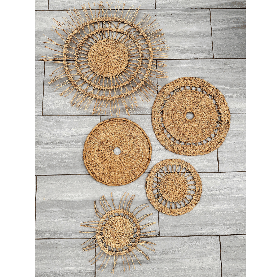 Set of woven wall art pieces on a wooden surface