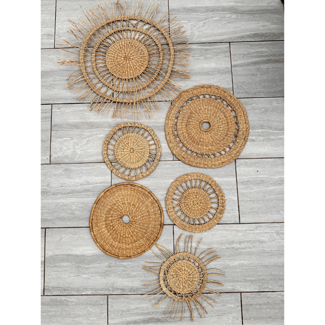 Set of woven rattan wall baskets on a wooden surface