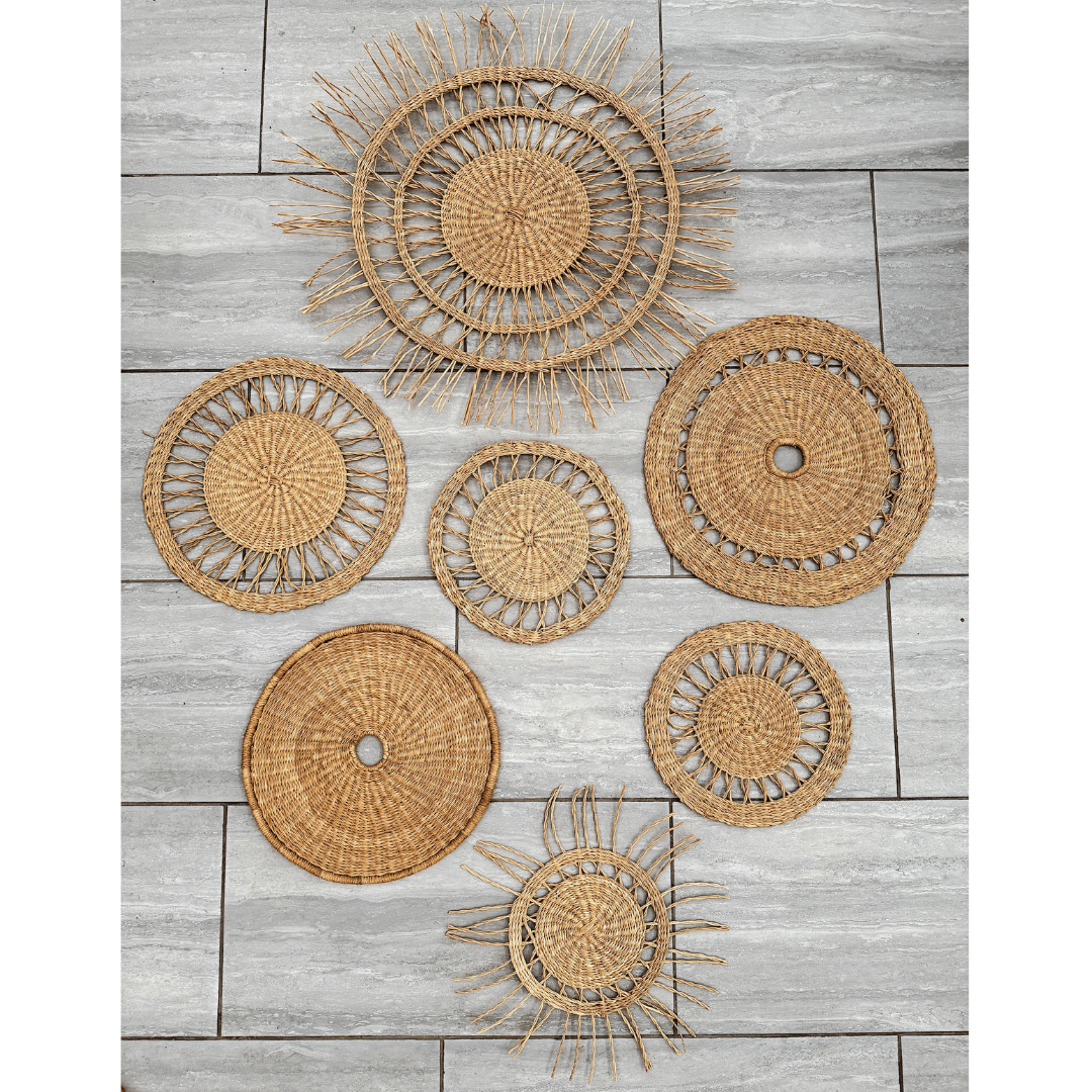 Set of woven rattan wall baskets on a wooden surface