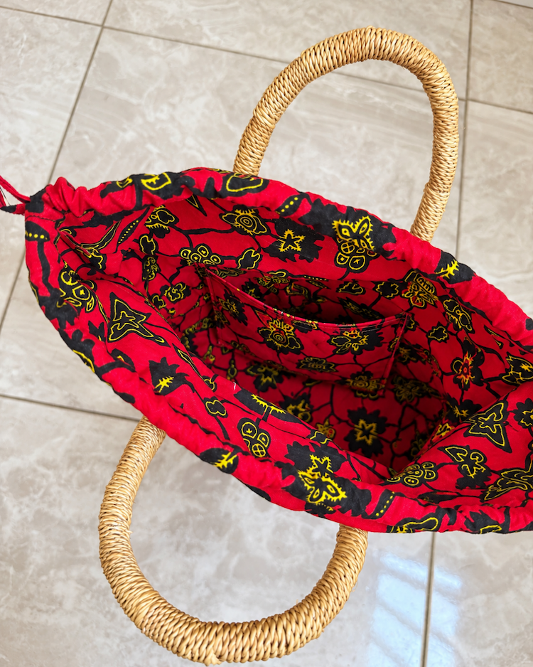 Handwoven straw handbag with its lining open