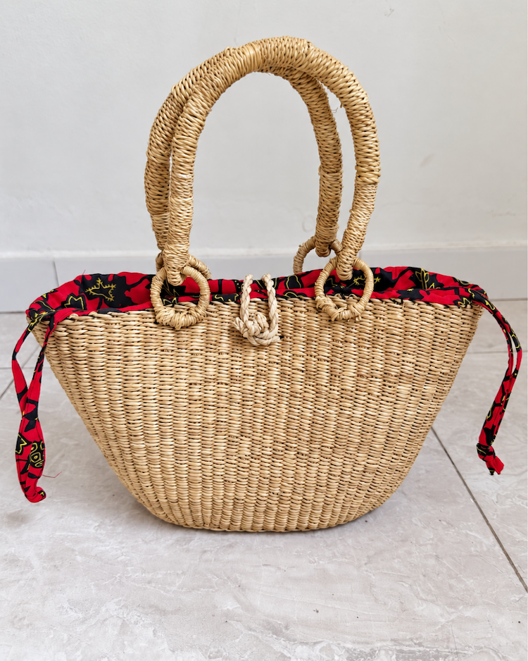 Handwoven straw handbag standing upright