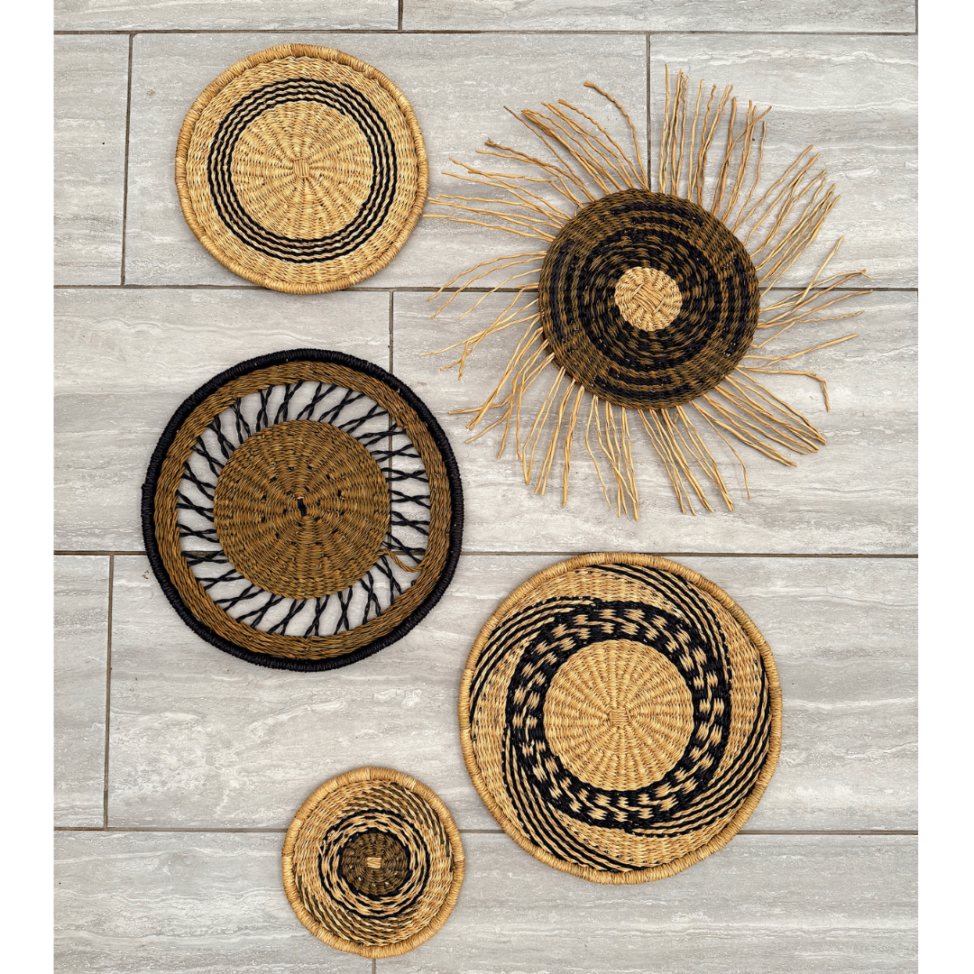 Set of woven wall art pieces on a wooden surface