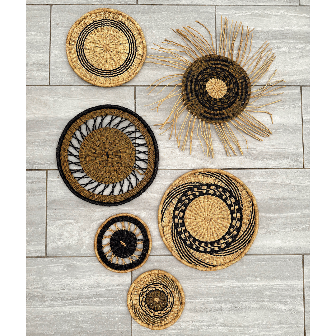 Set of woven wall art pieces on a wooden surface